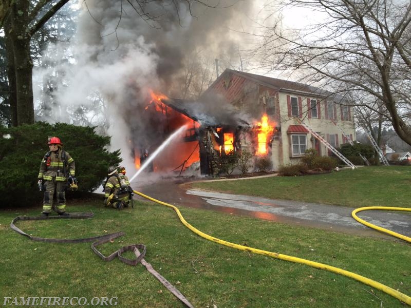 Engine 52-2 crew operates 2-1/2&quot; hoseline to darken down the bulk of the fire before it extends into the attached dwelling. An aggressive and coordinated attack led to a successful firefight at this afternoon dwelling fire on Greystone Drive in West Goshen Twp. 12-30-2015. PHOTO By: WGPD